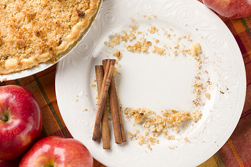 Image showing Pie, Apples, Cinnamon Sticks and Copy Spaced Crumbs on Plate