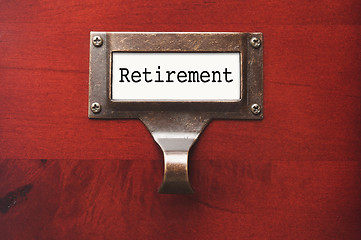 Image showing Lustrous Wooden Cabinet with Retirement File Label