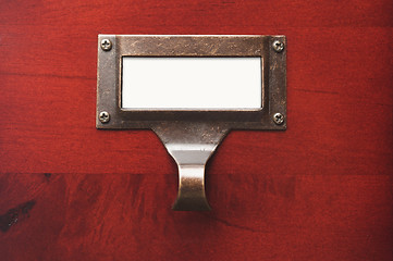 Image showing Lustrous Wooden Cabinet with Blank File Label