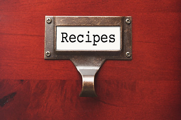 Image showing Lustrous Wooden Cabinet with Recipes File Label