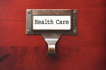 Image showing Lustrous Wooden Cabinet with Health Care File Label