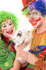 Image showing Two cheerful clown with a white rabbit