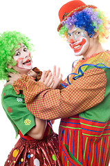 Image showing Clown tries to strangle a female clown