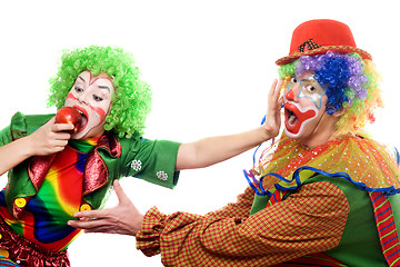 Image showing Clowns are fighting for an apple