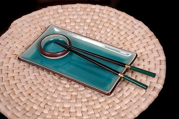 Image showing Plate, dipping bowl and chop sticks on mat