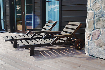 Image showing two wooden deck chairs on the terrace 