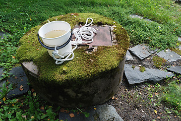 Image showing typical concrete water well with moss