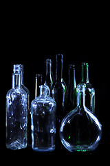 Image showing empty bottles in the night on the black background