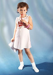 Image showing little  school girl  thinking on blue background