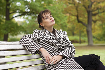 Image showing young girl relaxing in autumn park