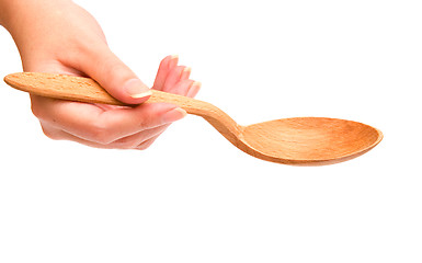 Image showing Hand holding wooden spoon 