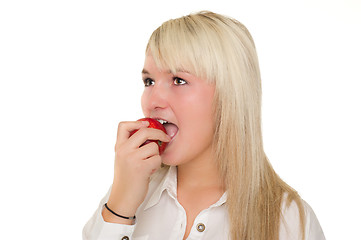 Image showing Young girl eating an apple