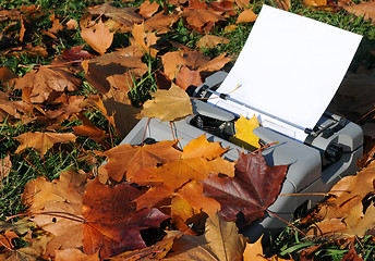 Image showing Old Typewriter and Fallen Maple Leaves