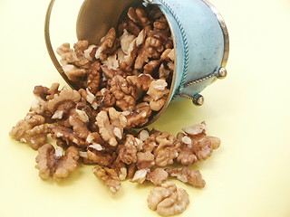 Image showing Metal vase with walnuts