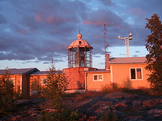 Image showing The setting sun shines on a lighthouse