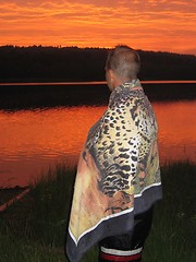 Image showing Boy in blanket watching the sunset