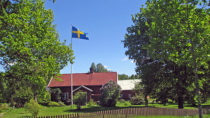 Image showing Swedish house and flag