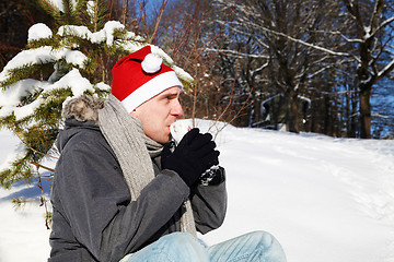 Image showing Man sitting in the snow