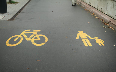 Image showing Asphalt road with yellow bike and pedestrian logo