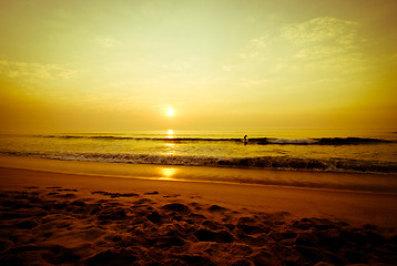 Image showing Surfers walking in the beach