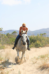 Image showing Young rider on the beach