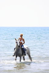 Image showing Young rider on the beach