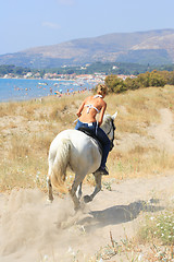 Image showing Young rider on the beach