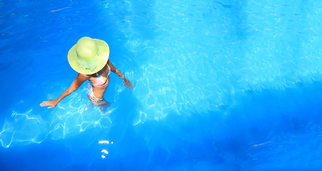 Image showing woman enjoying a swimming pool