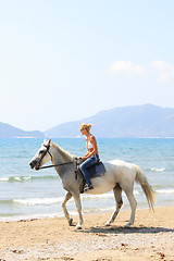 Image showing Young rider on the beach