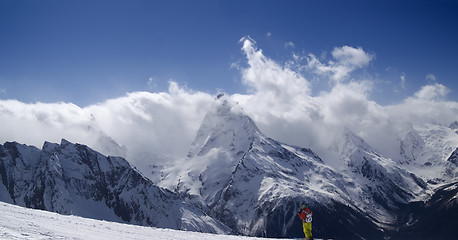 Image showing Panorama Mountains. Ski slope with skier. 