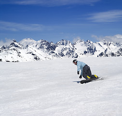 Image showing Snowboarder descends a slope