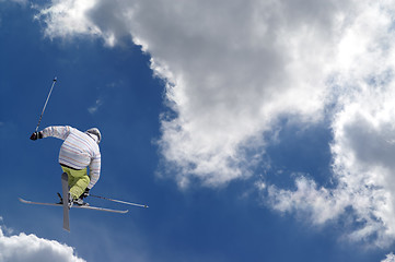 Image showing Freestyle ski jumper with crossed skis