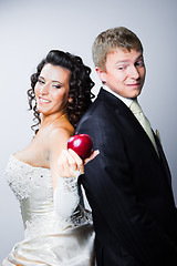 Image showing bride offering a red apple to doubting groom