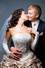 Image showing kissing bride and groom