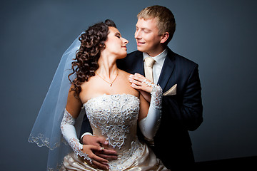 Image showing bride and groom embracing and looking at each other