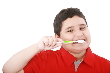 Image showing Beautiful boy brushing teeth, isolated on white 