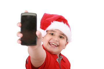 Image showing Little boy showing cell phone screen over white background. Boy 