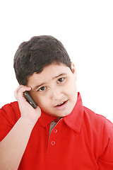 Image showing Young boy talking to cell phone, isolated on white background. 