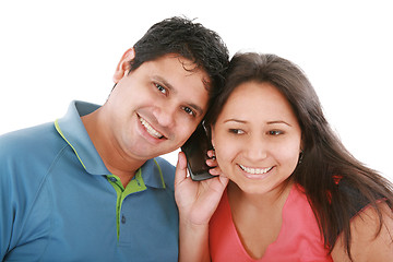 Image showing Couple are listening to a friend on a cell phone. 