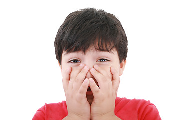 Image showing Preschool aged boy with his hand/fists over his mouth; looking e