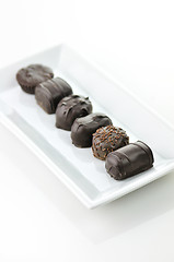 Image showing chocolate candies assortment in a white plate