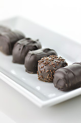 Image showing chocolate candies assortment in a white plate