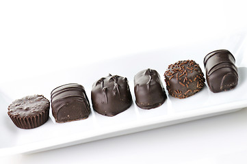 Image showing chocolate candies assortment in a white plate