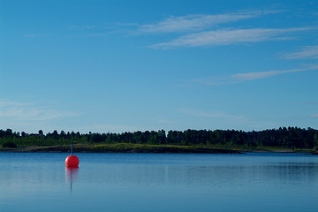 Image showing Orange buoy in calm waters