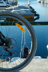 Image showing Bicycle wheel and boats