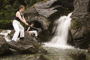 Image showing Two man training at waterfalls