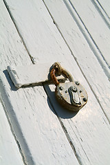 Image showing Detail of old, wooden door with padlock