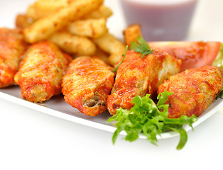 Image showing hot chicken wings with fried potatoes and sauce 