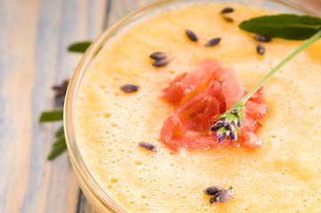 Image showing fresh melon soup with parma ham and lavender flower