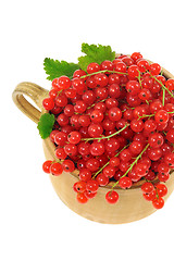 Image showing Ceramic cup full of fresh red currant berries. Clipping path included